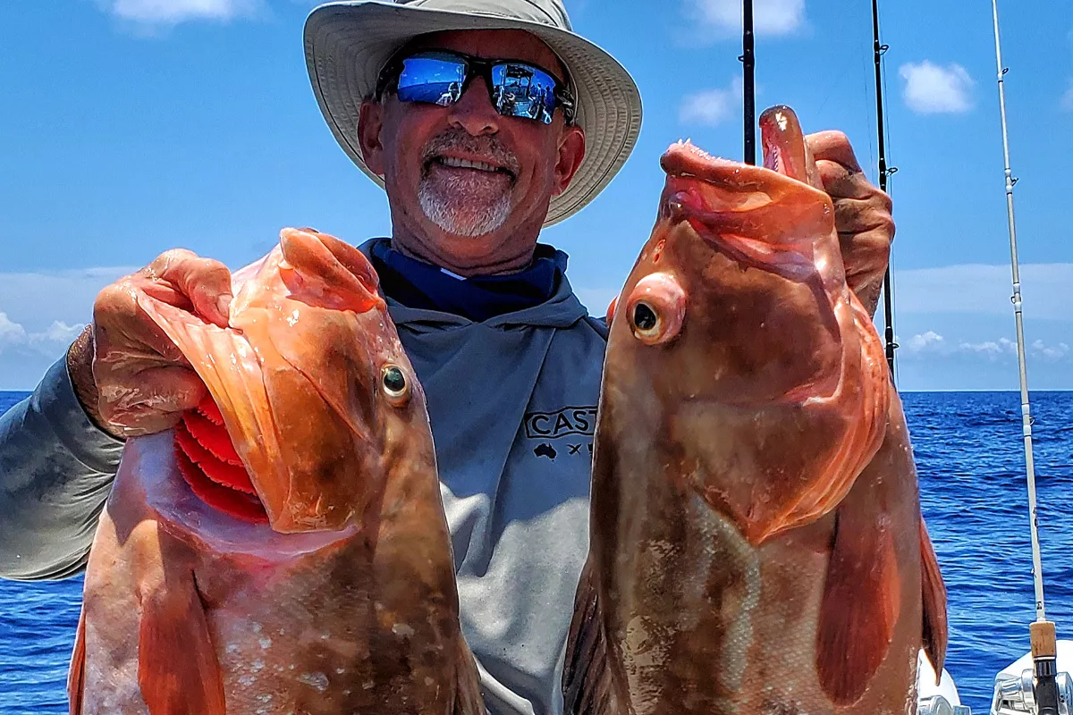 Kevin Adney holding red grouper caught Bottom Fishing