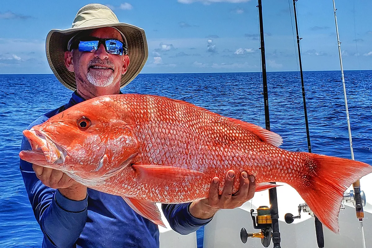 Bottom Fishing fisherman catches Red Snapper