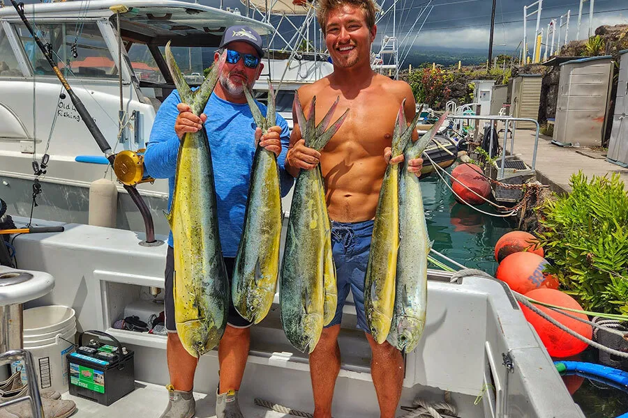 Captain Shawn Rotella holds up mahi mahi caught trolling off of Kona