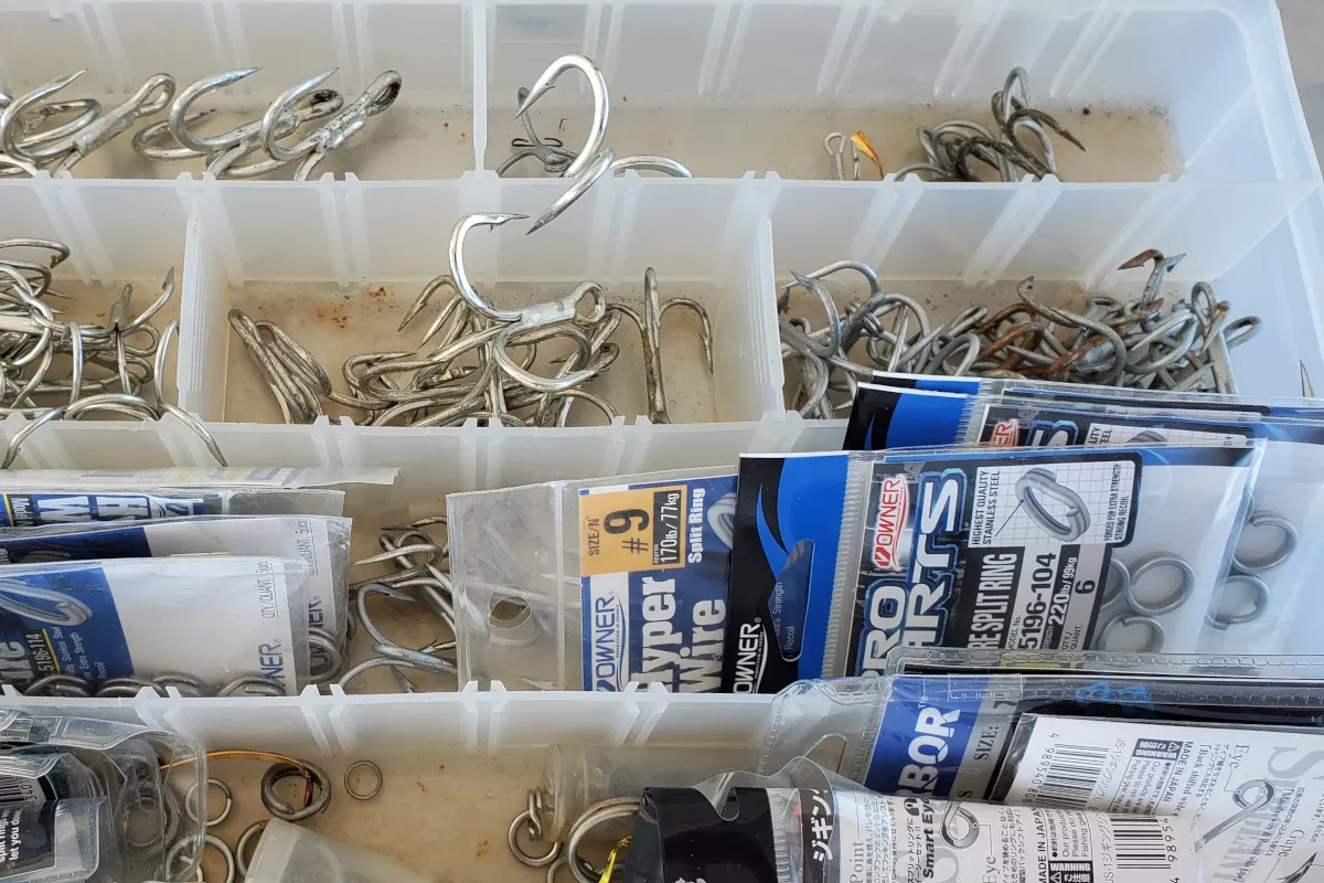 box of hooks and split rings for giant trevally