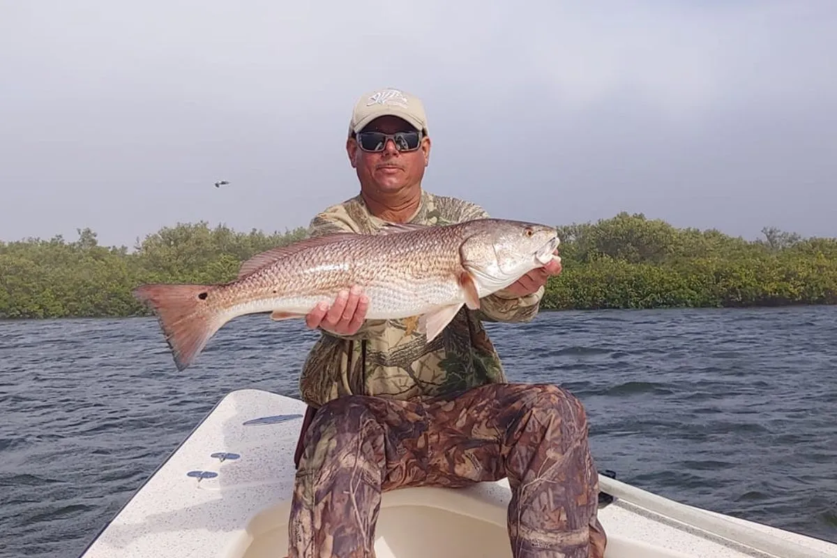 fisherman fishing cold weather redfish