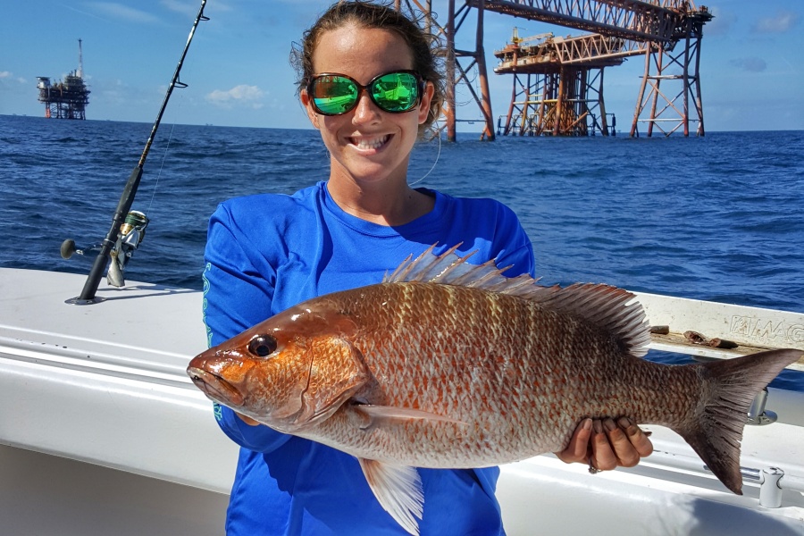 Capt. Josh Howard holds a nice mangrove snapper caught chumming in Louisiana