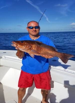 Capt. Josh Howard holds a nice mangrove snapper caught chumming in Louisiana