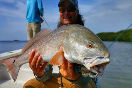 William Toney holds Redfish caught on hard shell bottom