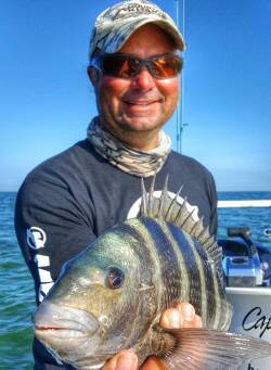 William Toney holding striped bandit while filming How to Catch Sheepshead Fishing Video
