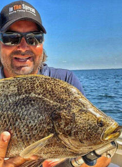 Florida inshore fishing guide William Toney holds a tripletail fish