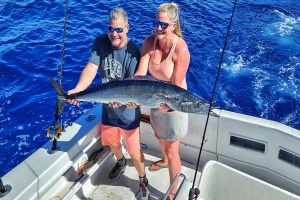 Shawn Rotella holding a wahoo caught slow trolling live bait in Hawaii