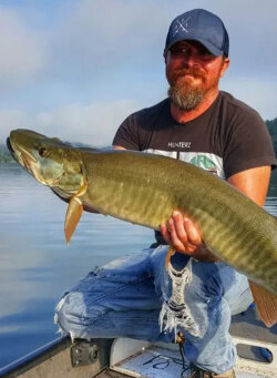 muskie fishing guide Cory Allen holds up a nice 50 inch fish