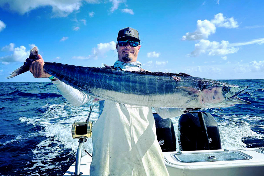 Mike Dupree reels in a wahoo while slow trolling