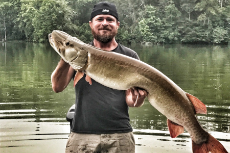 muskie fishing guide Cory Allen holds up a nice 50 inch fish
