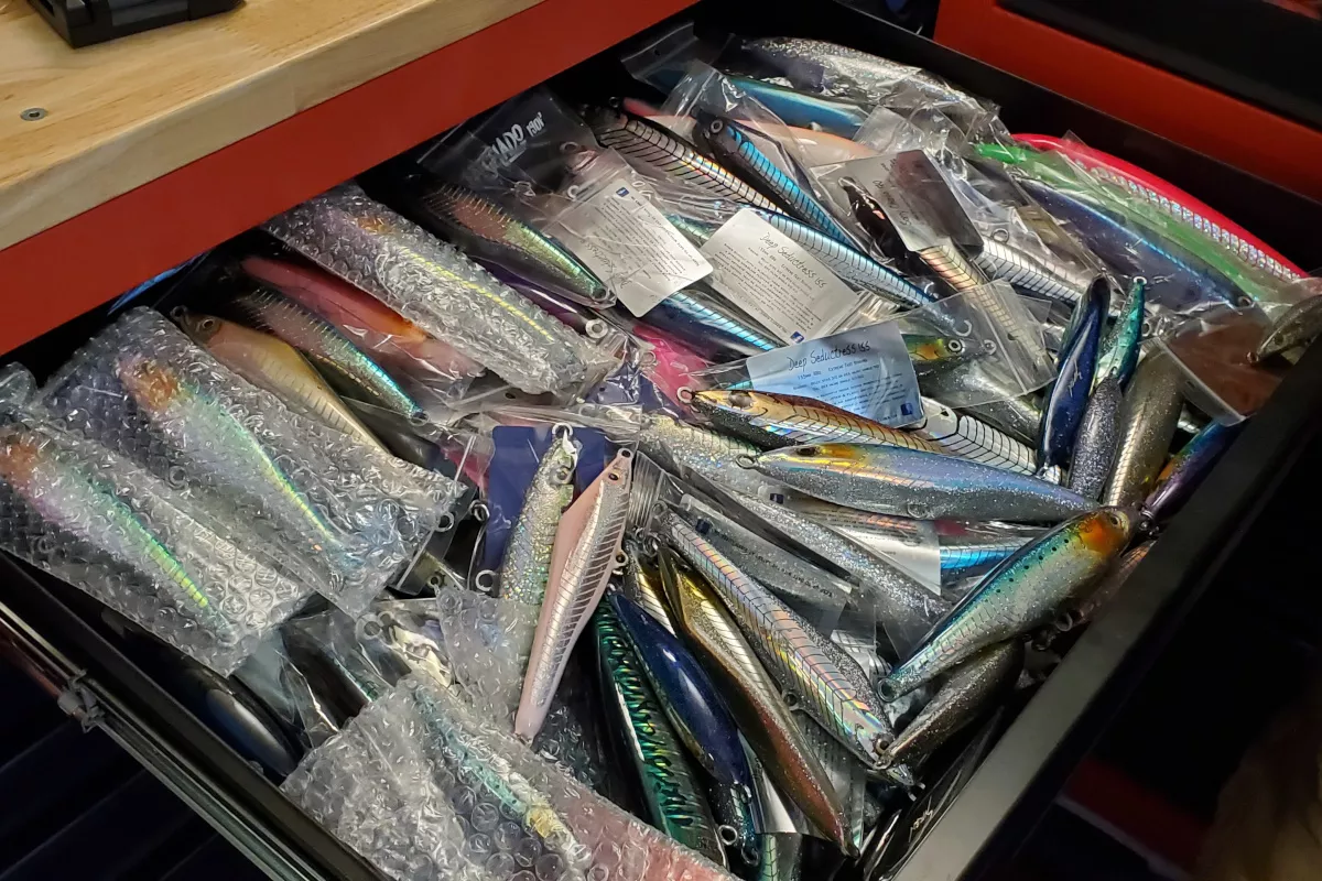 drawer full of stickbaits for giant trevally GT fishing