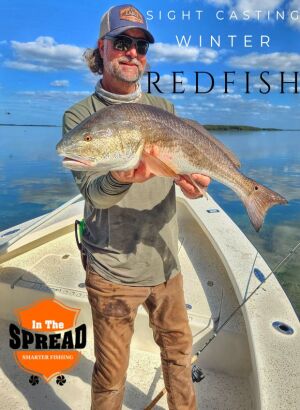 William Toney stands in his skiff with a 31 inch winter redfish caught sight casting on Homosassa flats